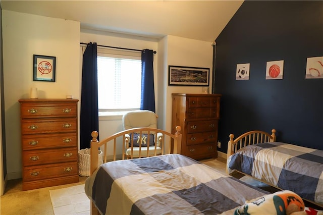 bedroom with lofted ceiling and light carpet