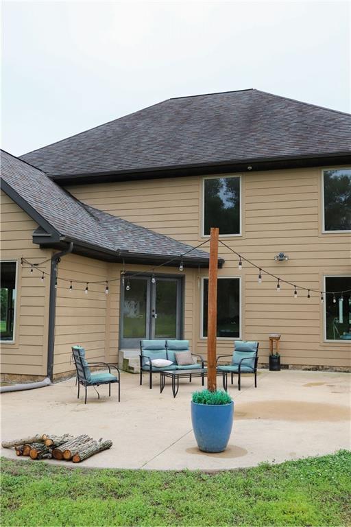 rear view of house with an outdoor hangout area and a patio area