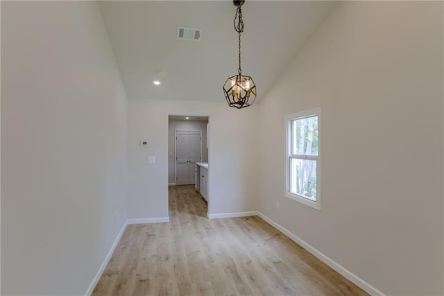812 S Saville St, Independence, MO 64050 - unfurnished dining area with baseboards, light wood-type flooring, a chandelier, high vaulted ceiling, and recessed lighting
