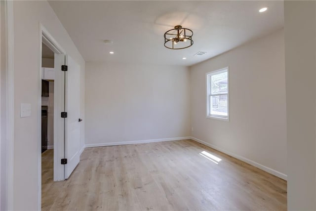 812 S Saville St, Independence, MO 64050 - spare room featuring a chandelier, light wood-style flooring, baseboards, and recessed lighting