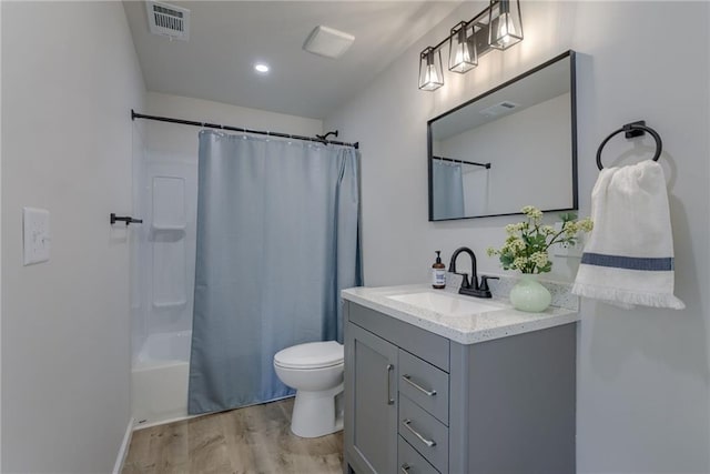 812 S Saville St, Independence, MO 64050 - full bathroom with wood finished floors, vanity, toilet, and shower / tub combo with curtain