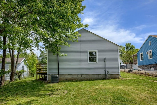 812 S Saville St, Independence, MO 64050 - view of home's exterior with a wooden deck and central AC