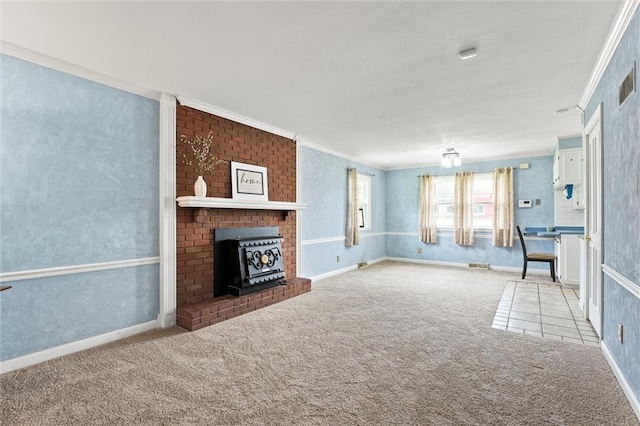 unfurnished living room featuring visible vents, ornamental molding, a wood stove, baseboards, and carpet flooring