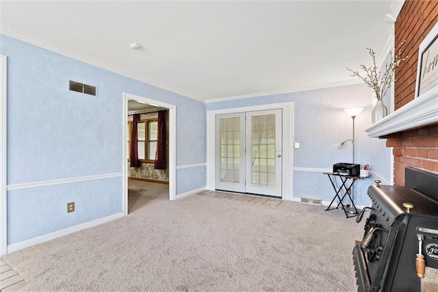 sitting room featuring visible vents, ornamental molding, carpet floors, and french doors