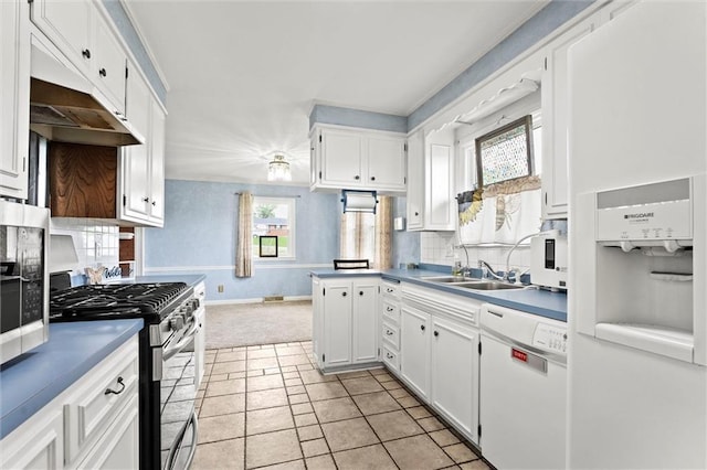 kitchen featuring white cabinets, a sink, dishwasher, decorative backsplash, and gas range
