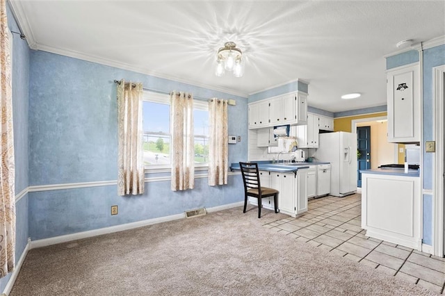 kitchen featuring visible vents, ornamental molding, white cabinets, and white refrigerator with ice dispenser