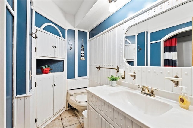 bathroom with vanity, tile patterned floors, and toilet