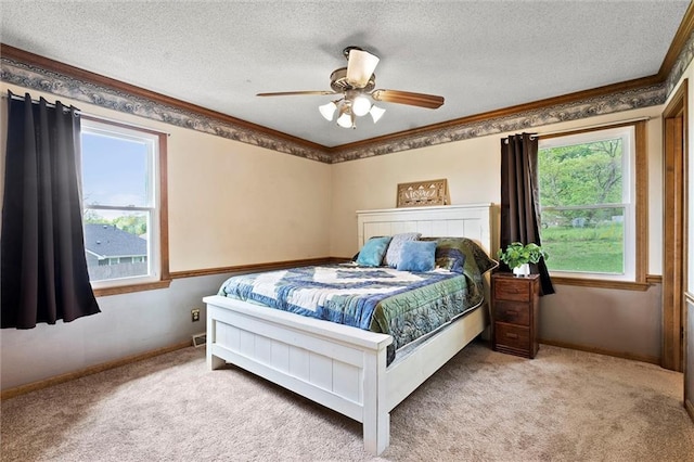 bedroom with carpet floors, ornamental molding, and a textured ceiling