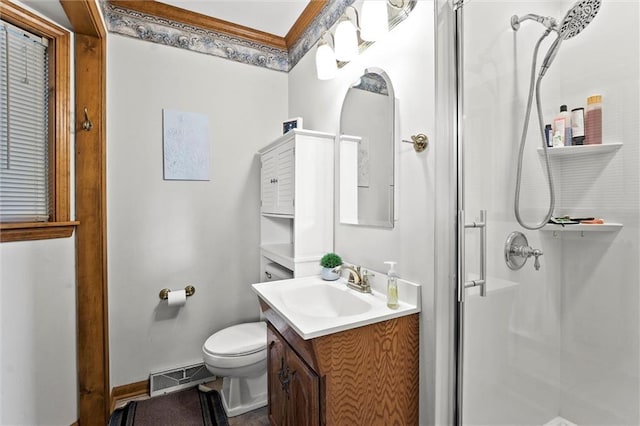 bathroom featuring visible vents, a stall shower, vanity, baseboards, and toilet