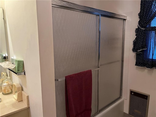 full bathroom featuring heating unit and enclosed tub / shower combo