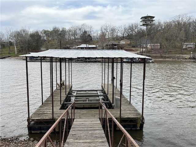 dock area with a water view and boat lift
