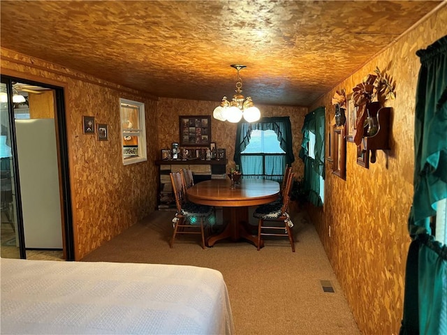 dining room featuring an inviting chandelier, carpet, and visible vents