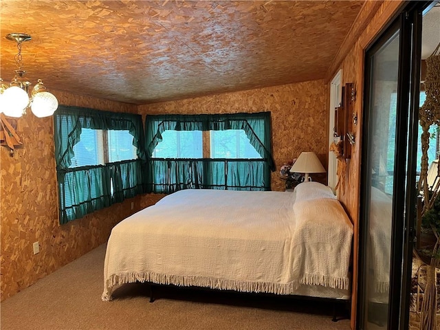 carpeted bedroom featuring a chandelier