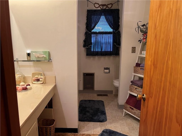 bathroom featuring visible vents, tile patterned flooring, vanity, toilet, and heating unit