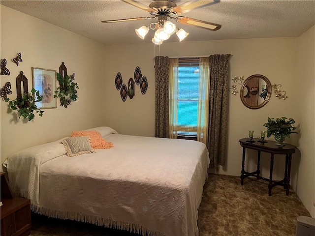 bedroom with ceiling fan, dark colored carpet, and a textured ceiling