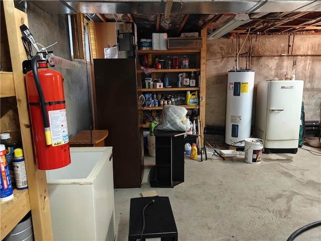 unfinished basement with refrigerator and electric water heater