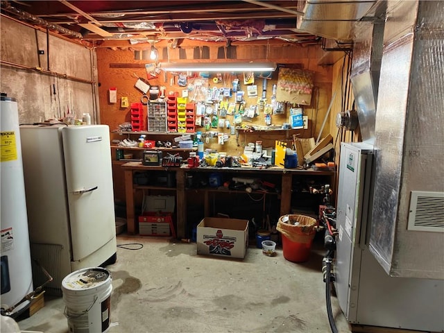 unfinished basement featuring water heater, a workshop area, and heating unit