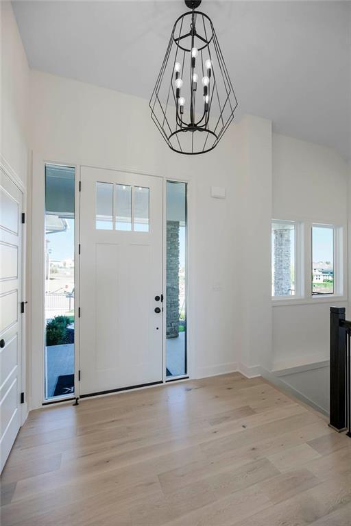12541 S Hedge Ct, Olathe, KS 66061 - entryway with light wood-type flooring and a chandelier