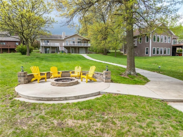 view of yard with a patio, a fire pit, and a wooden deck
