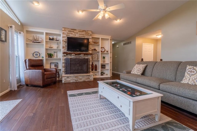 living room with a ceiling fan, visible vents, a fireplace, vaulted ceiling, and dark wood-type flooring