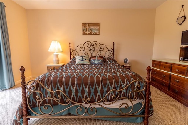 bedroom with baseboards and carpet