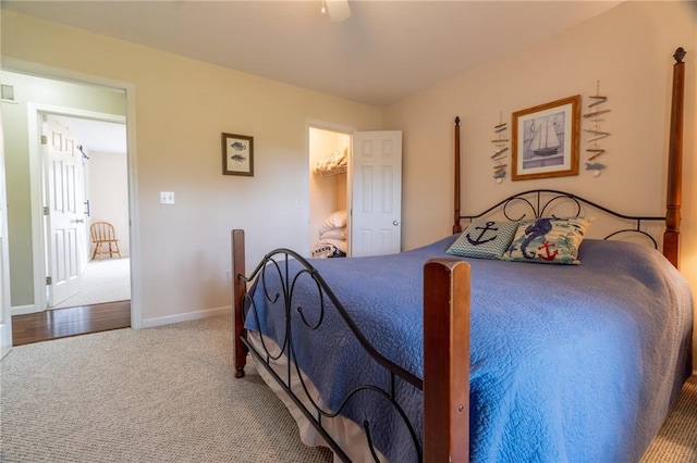 carpeted bedroom featuring baseboards and ceiling fan