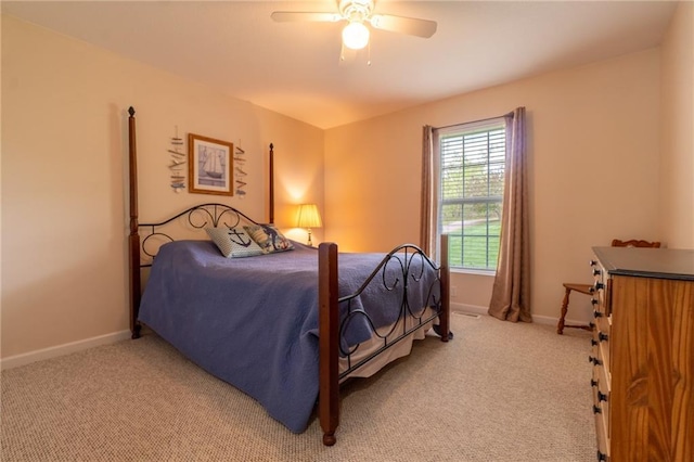 bedroom with baseboards, a ceiling fan, and light carpet