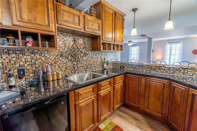 kitchen featuring open shelves, a sink, light wood finished floors, decorative backsplash, and dishwashing machine
