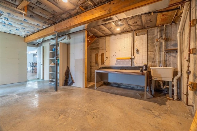 unfinished below grade area featuring a workshop area and a sink