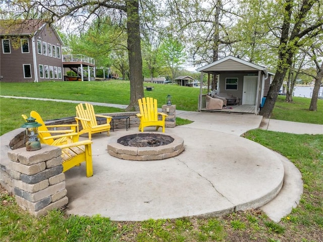 view of patio / terrace featuring an outdoor fire pit and a deck