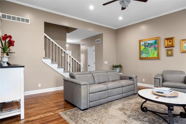 living room with a ceiling fan, baseboards, visible vents, and wood finished floors