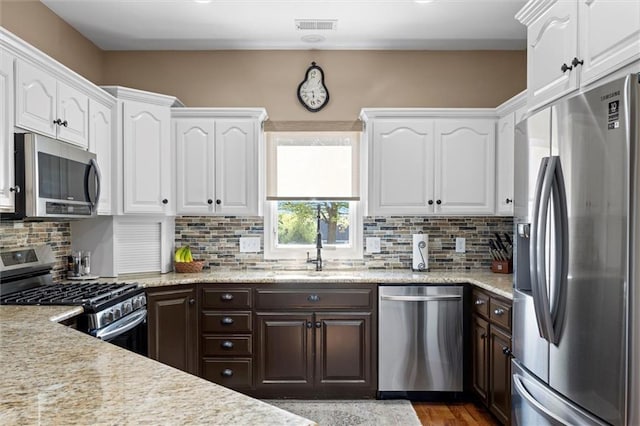 kitchen with visible vents, a sink, white cabinetry, and appliances with stainless steel finishes