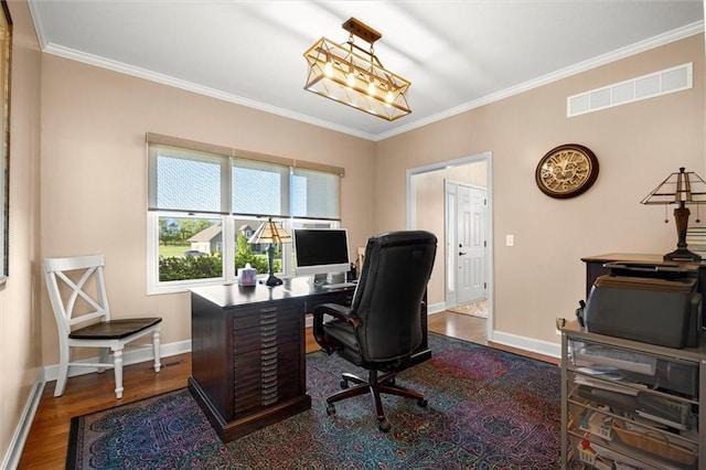 office featuring baseboards, visible vents, ornamental molding, and wood finished floors