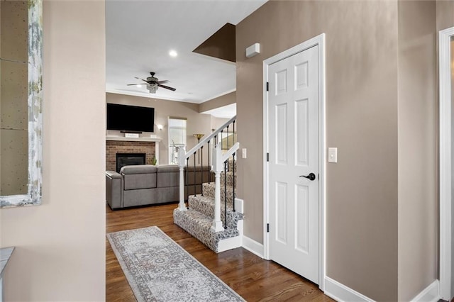 hallway with stairway, baseboards, and wood finished floors