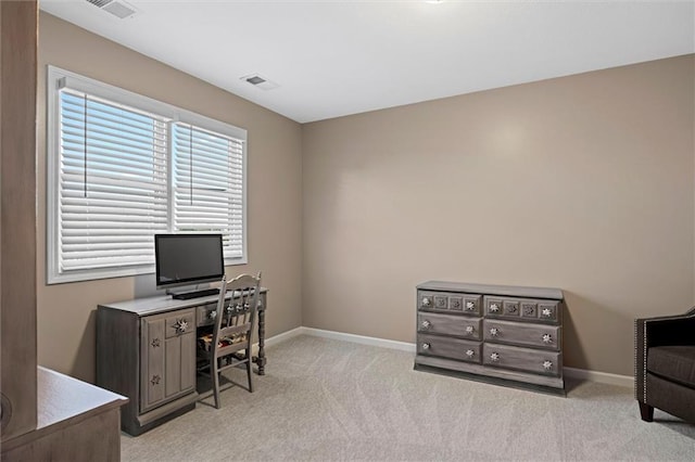 home office featuring visible vents, baseboards, and light carpet