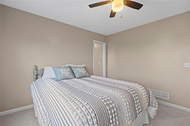 carpeted bedroom featuring a ceiling fan, baseboards, and visible vents