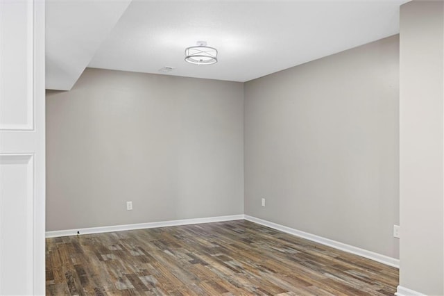 empty room featuring baseboards and wood finished floors