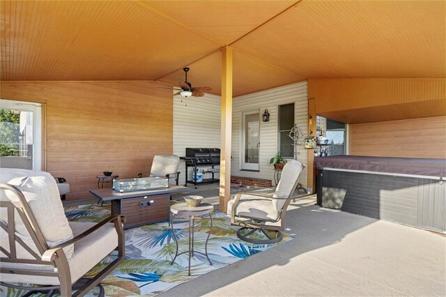 view of patio featuring a hot tub, grilling area, and a ceiling fan