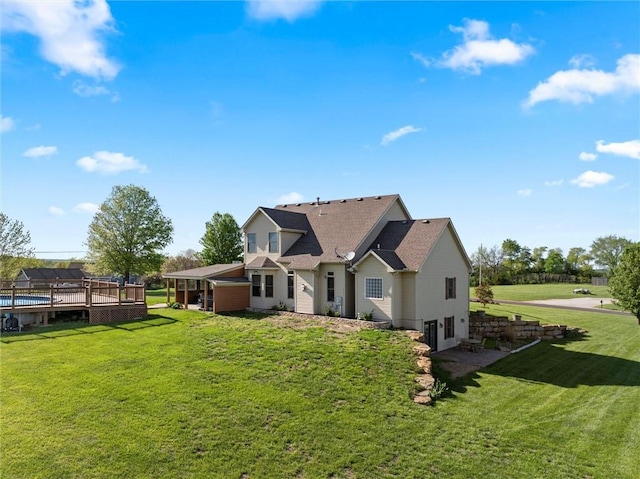 view of front facade featuring a shingled roof and a front lawn
