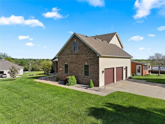 view of side of home with brick siding, roof with shingles, a yard, and concrete driveway