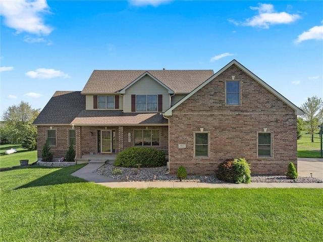 view of front of home featuring a porch, brick siding, and a front lawn