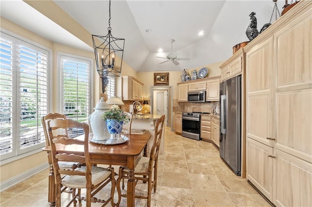 dining space featuring a ceiling fan, a wealth of natural light, lofted ceiling, and baseboards