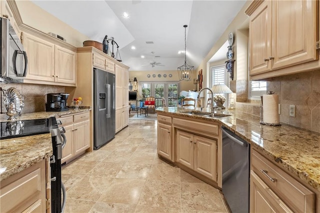 kitchen featuring a ceiling fan, stainless steel appliances, decorative backsplash, and a sink