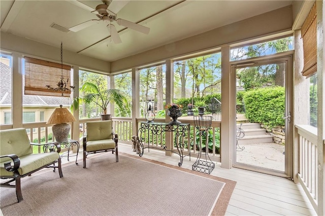 sunroom featuring ceiling fan, a wealth of natural light, and wood finished floors