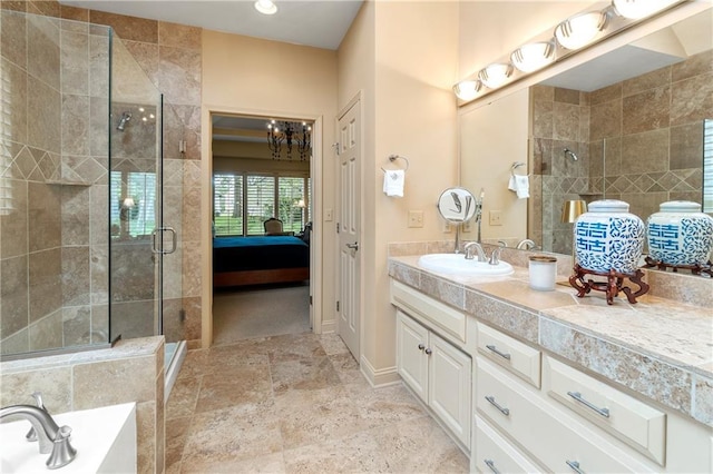 full bath featuring a tub, vanity, ensuite bath, and a shower stall