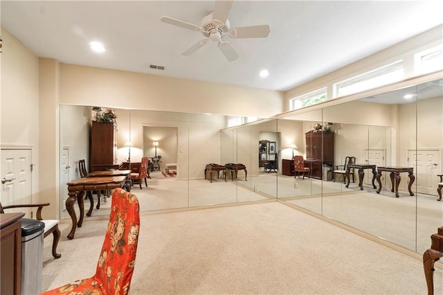 interior space with ceiling fan, visible vents, and carpet floors