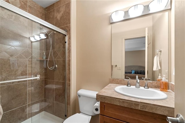 ensuite bathroom featuring ensuite bath, a shower stall, vanity, and toilet