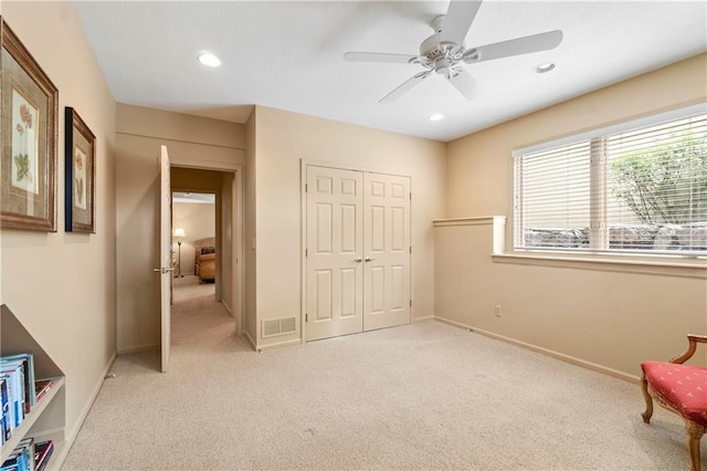 unfurnished room with a ceiling fan, visible vents, baseboards, light carpet, and recessed lighting