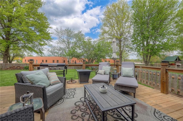 wooden deck with a lawn, fence, and area for grilling