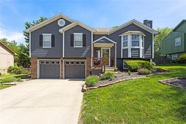 raised ranch with brick siding, an attached garage, concrete driveway, and a chimney